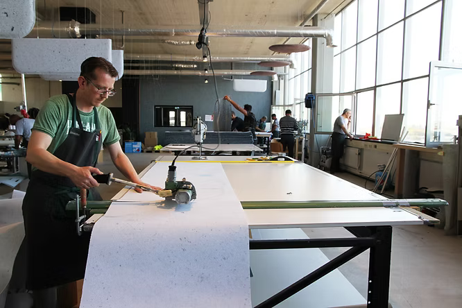 Sylvester, operator bij i‑did Factory, aan het werk met machines voor het produceren van vilt